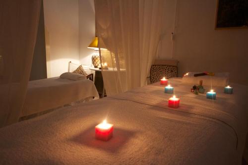 a group of candles sitting on top of a bed at Il San Francesco Charming Hotel in Sabaudia