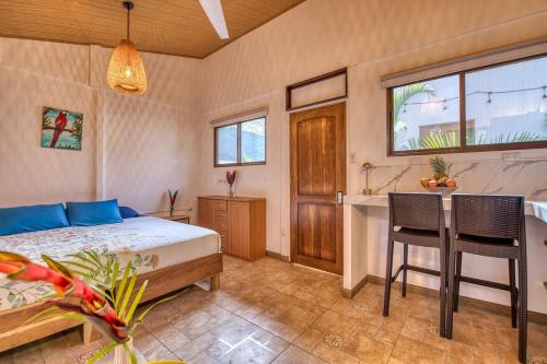a bedroom with a bed and a table and chairs at Beachfront Studio - King Bed - Fast WiFi - AC in Cocles