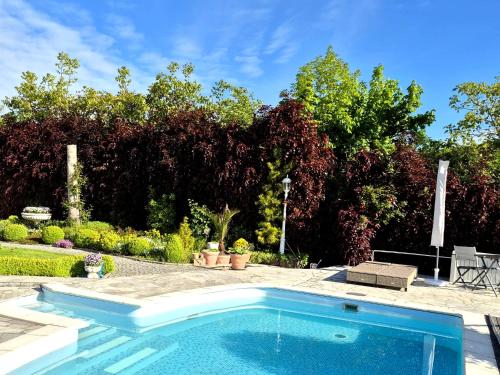 a swimming pool in front of a garden at Ihre Auszeit am Golfplatz in Meisdorf