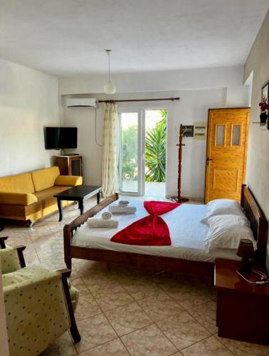 a bedroom with a large bed and a couch at Dimora Seaside Apartments in Ksamil