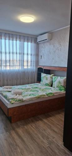 a bedroom with a large bed in a room at Harmonia in Ruse