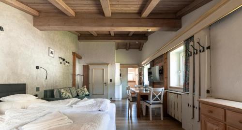 a bedroom with a bed and a dining room at Beim Franz in Lermoos