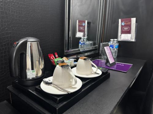 a hotel room counter with two coffee makers on it at Verve Hotel in Bedford