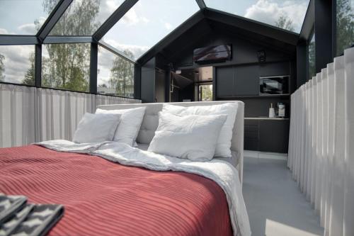 a bedroom with a large bed with white pillows at Lunar igloos - Kaamos in Karkku