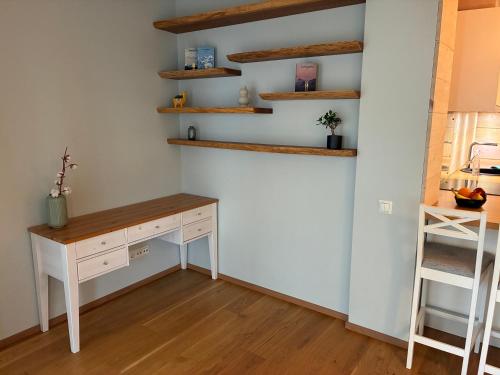 a room with a desk and shelves on the wall at Viimsi Apartment in Haabneeme