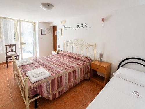 a bedroom with a bed and a table and a window at Camera Cafè Affitta camere in Nardò