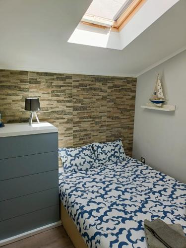 a bedroom with a bed and a dresser and a window at NEW - Casa Rocha in Sesimbra