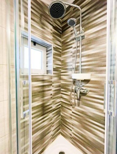 a bathroom with a shower with a toilet and a sink at NEW - Casa Rocha in Sesimbra