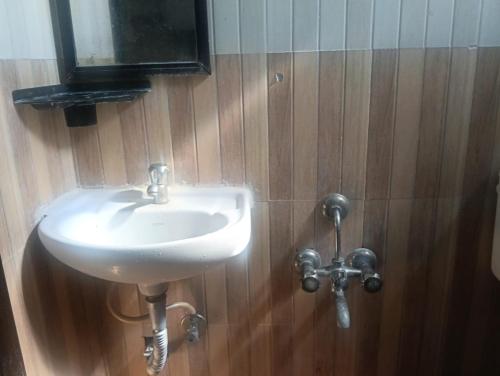 a bathroom with a white sink and a mirror at coastal charm in Chennai