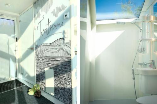 a bathroom with a shower with a painting on the wall at Lunar Igloos - Lumi in Karkku