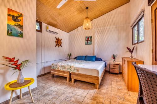 a bedroom with a bed and a table at Beachfront Studio - King Bed - Fast WiFi - AC in Cocles