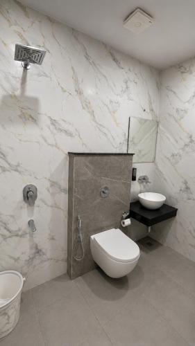 a bathroom with a toilet and a sink at Hotel Golden Plaza in Amritsar