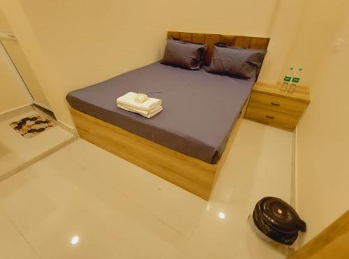 a bedroom with a bed with two towels on it at Hotel Mahakal Ujjain Prime in Ujjain