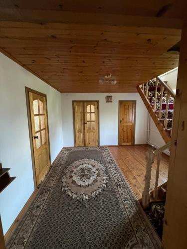 an empty room with a staircase and a rug at Village stay in Kaindy