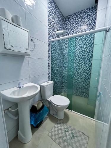 a bathroom with a toilet and a sink and a shower at Flats Praia de Gravatá in São José da Coroa Grande