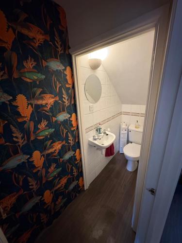 a bathroom with a sink and a toilet at Sunset at Horizon in Castel