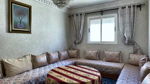 a living room with a couch and a window at Melilla Gate House in Nador