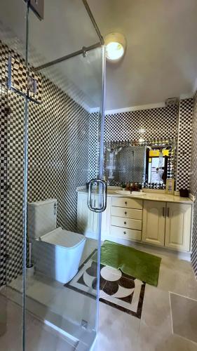 a bathroom with a shower and a sink at Melilla Gate House in Nador