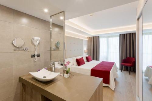a hotel room with a bed and a sink at Hotel Beverly Park & Spa in Blanes