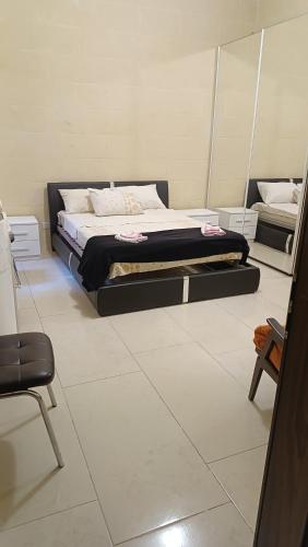 a bedroom with a bed in a room at Tan-Nahal Court Apartment, Sannat Gozo in Sannat
