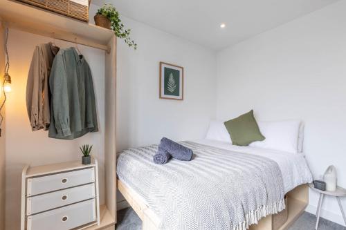 a bedroom with a bed and a dresser at 11 Dune View in Braunton