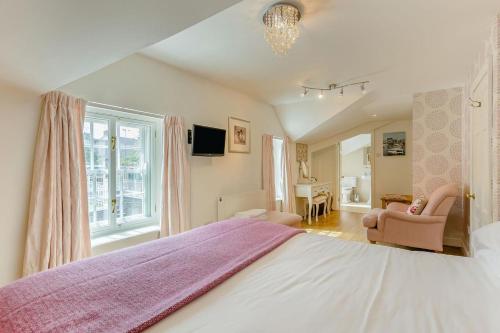 a bedroom with a large bed with a purple blanket at 3 Bed in Aberaeron oc-86578 in Aberaeron