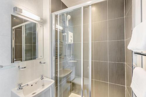 a bathroom with a shower and a sink and a toilet at 3 Bed in Aberaeron oc-86578 in Aberaeron