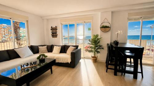 a living room with a couch and a table and a piano at Mar, terraza y parking in Santa Pola