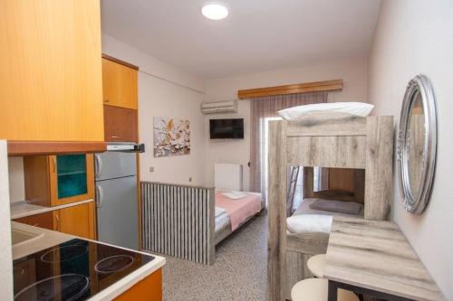 a small kitchen with a bunk bed in a room at Azura Studios in Stavros