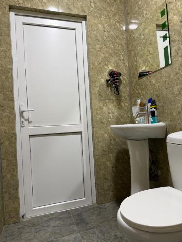 a bathroom with a toilet and a sink at MaVi House in Kutaisi