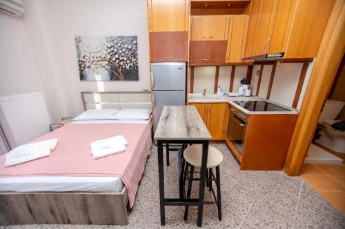 a small room with two beds and a small kitchen at Azura Studios in Stavros