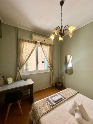 a bedroom with a bed and a desk and a window at Oscar - City Center Rooms Athens in Athens