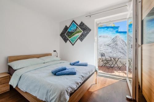 a bedroom with a bed with blue pillows on it at Penzion Hosnar in Bovec