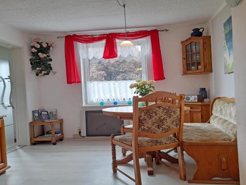 a dining room with a table and a window at Ferienhaus Figelski in Sassnitz