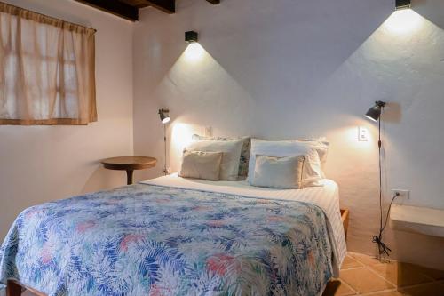 a bedroom with a large bed with two pillows at Posada Casa Play Los Roques in El Roque