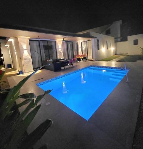 a large swimming pool lit up at night at Villa La Vida Dulce Private Pool Near Playa Dorada in Puerto Plata