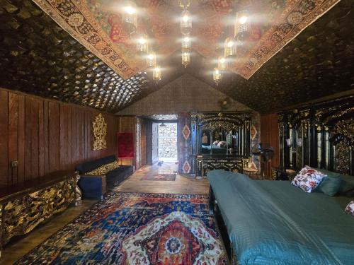 a bedroom with a bed and a ceiling with a rug at Dar Al Masyaf in Sharan