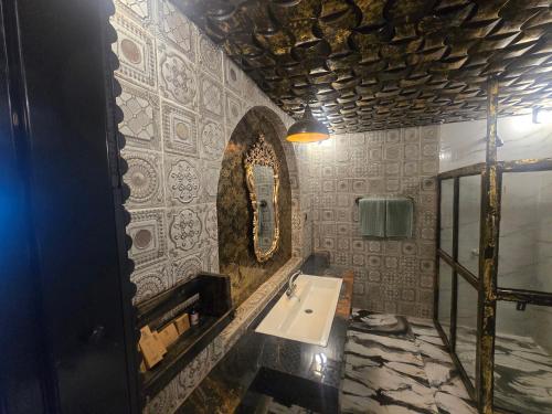 a bathroom with a sink and a mirror at Dar Al Masyaf in Sharan