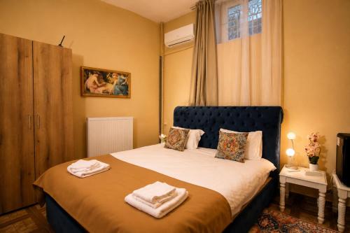 a bedroom with a bed with towels on it at Maison BERTHELOT in Bucharest
