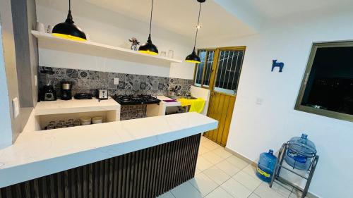 a kitchen with a stove and a counter top at Departamento scorpio in Tuxtla Gutiérrez