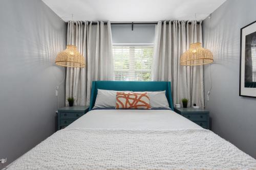 a bedroom with a bed and two chandeliers at Plaza Condo With Queen Bed 3 in Kansas City