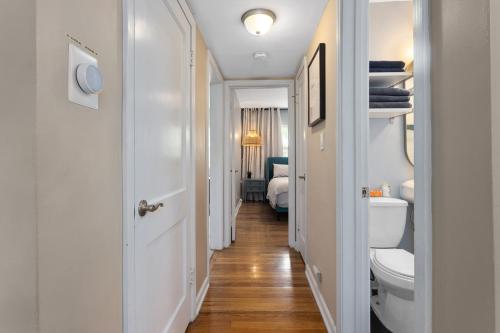 a corridor of a bathroom with a toilet and a bedroom at Plaza Condo With Queen Bed 3 in Kansas City