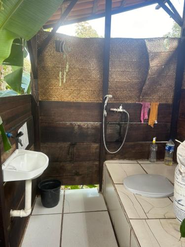 a bathroom with a shower and a toilet and a sink at Golden refuge in Vale do Capão in Passagem