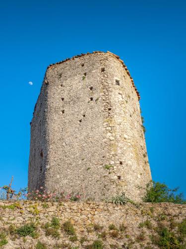 a tall stone tower on top of a hill at Da Nonna Pasqualina in Ciorlano