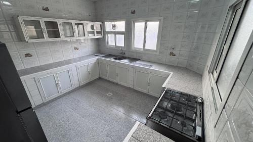 an overhead view of a kitchen with white cabinets at Family Beach Villas in Salalah