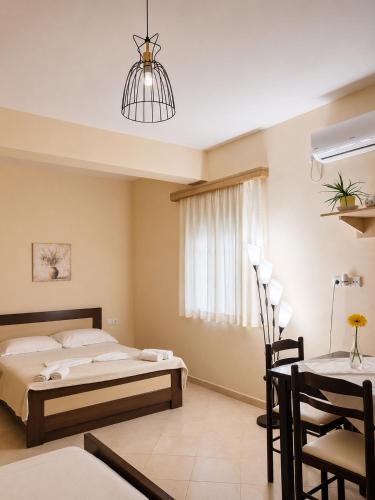 a bedroom with a bed and a dining table at Erika's House in Lukovë