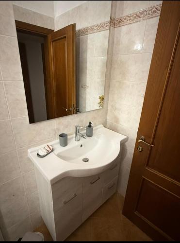 a bathroom with a white sink and a mirror at Casa Di Francia in Pontedera