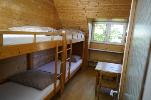 a room with three bunk beds in a cabin at Feriencamp Sibley - Gruppenhaus im Nationalpark Kalkalpen in Laussa