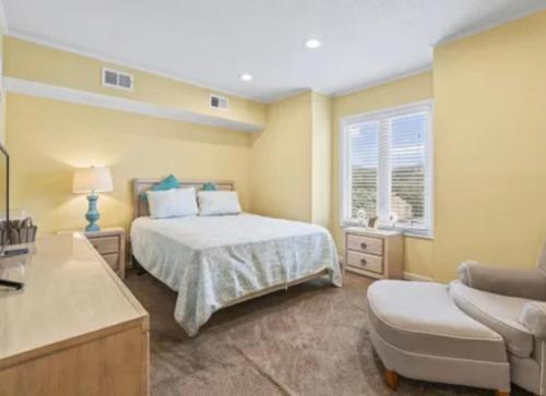 a bedroom with a bed and a couch and a chair at MarzyMagic Oceanview's in Myrtle Beach