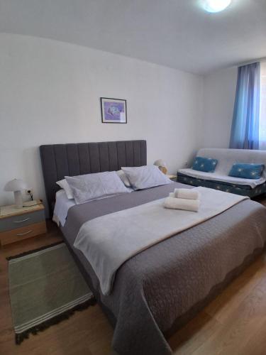 a bedroom with a large bed in a room at Pet friendly Apartments Licul in Rabac